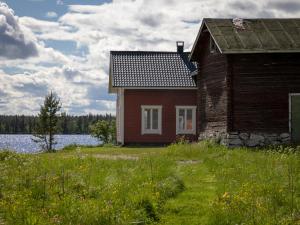a house in a field next to a body of water at Villa Aattu in Muonio +42 photos