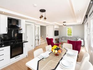 a kitchen and living room with a table and chairs at Villa Delfin in Ortaca