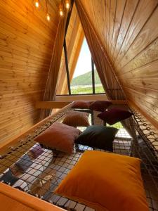 an attic room with pillows on the floor at A Frame 2 Transalpina in Sebeş