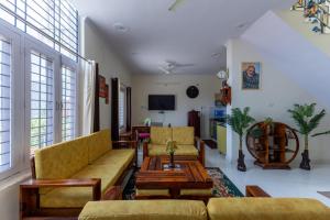 a living room with couches and a coffee table at Vrishti Homestay in Bhīm Tāl