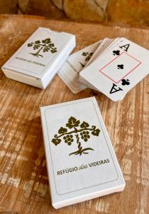three playing cards sitting on top of a table at Chalé da Árvore - Refúgio das Videiras in Moeda