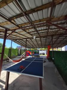 a pavilion with a ping pong table and hammocks at Guest House in Ureki in Ureki