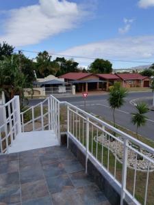 a white fence in front of a street at The Room Above in Brackenfell
