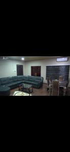 a living room with a green couch and chairs at Sunlight Guest house in Ofankor