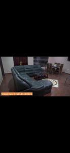 a living room with a bunch of leather couches at Sunlight Guest house in Ofankor