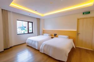 a bedroom with two beds and a window at Hera Hotel in Hanoi +7 photos