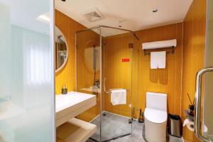 a bathroom with a toilet and a sink and a shower at Hera Hotel in Hanoi