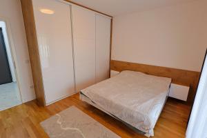 a small bedroom with a bed and a closet at Tuzla Tower in Ši Selo