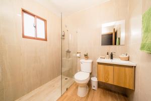 a bathroom with a toilet and a sink and a shower at Villa Campestre by Otium in Higuey +59 photos