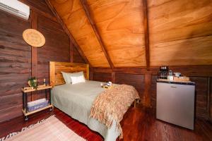 a bedroom with a bed in a wooden room at Villa Campestre by Otium in Higuey