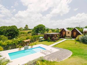 an estate with a swimming pool and a house at Villa Campestre by Otium in Higuey