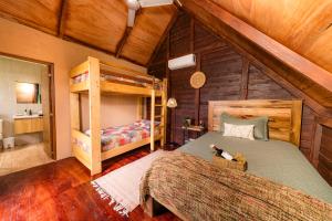 a bedroom with two bunk beds and a bathroom at Villa Campestre by Otium in Higuey