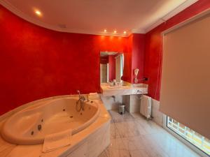a red bathroom with a tub and a sink at Marina de Campios in Comillas +78 photos