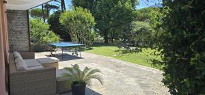 a patio with a table and a bench and a picnic table at Luna in Lierna