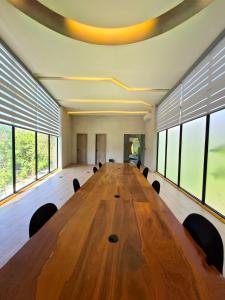 a large wooden table in a large room with windows at Private Pool with Beach Access and Baby Crib - Tulum Hotel Zone in Tulum +66 photos