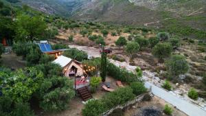 an aerial view of a house in a mountain at Billion Stars in Thymonia Beach