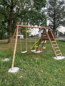 a playground with a swing set in a park at Chez Virginie in Rhodes