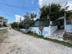 a dirt road in front of a house at Lili's House in Delvinë