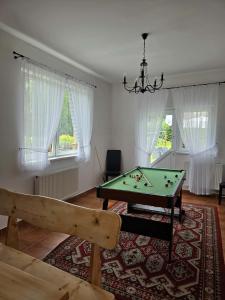 a living room with a pool table and windows at Willa Kamila in Poronin