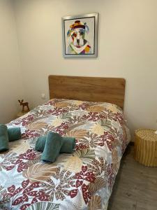 a bedroom with a bed with a comforter on it at Chez Virginie in Rhodes