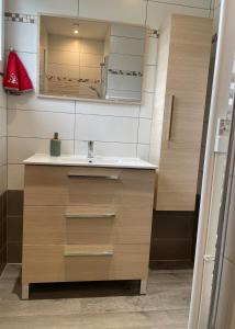 a bathroom with a sink and a mirror at Chez Virginie in Rhodes +8 photos