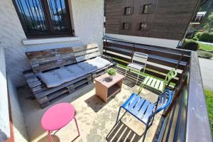 an overhead view of a patio with chairs and a bench at Studio at the foot of the ice rink in Le Grand-Bornand
