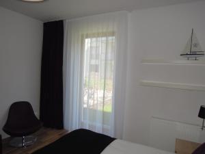 Posteľ alebo postele v izbe v ubytovaní Apartamenty Karawela - Nadmorski Dwór