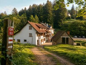 a house on the side of a dirt road at Les2Châteaux in Windstein