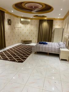 a bedroom with a large bed and a ceiling at شقة عوقد in Okkad
