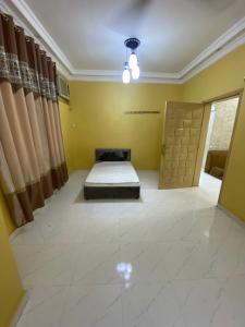 a bedroom with a bed in a room with a door at شقة عوقد in Okkad