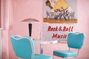 a dining room with a table and two chairs at RomanticHOTEL Goldener Karpfen - das kleine, feine Grandhotel direkt in der Altstadt in Fulda +27 photos