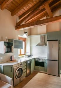 a kitchen with green cabinets and a stove top oven at APARTAMENTOS PUENTEDEY in Puentedey