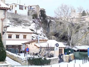 a village covered in snow with a mountain in the background at APARTAMENTOS PUENTEDEY in Puentedey +10 photos