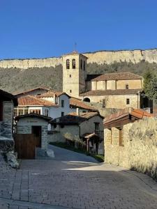 a group of buildings with a mountain in the background at APARTAMENTOS PUENTEDEY in Puentedey