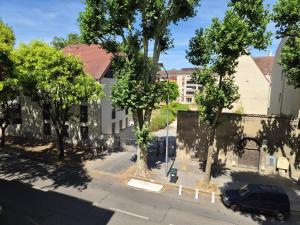 an aerial view of a street with trees and buildings at Le rempart in Chalon-sur-Saône