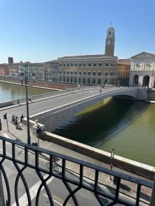 a bridge over a body of water in a city at Lungarno Suite in Pisa