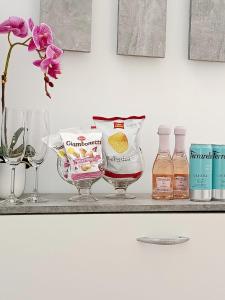 a shelf with a bunch of liquids and bottles of alcohol at DOS Gardenias B&B in Pozzuoli