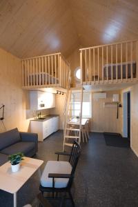 a living room with a couch and a bunk bed at Bygdsiljums Sjöbodar in Bygdsiljum