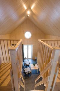 an attic room with stairs and a chair and a table at Bygdsiljums Sjöbodar in Bygdsiljum