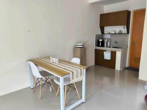 a small kitchen with a table and chairs in a room at Sta Cruz Laguna Transient House in Santa Cruz