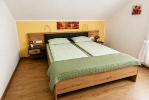 a bedroom with a large bed with two pillows at Ferienwohnung Blumäcker Oberbayern in Oberhausen