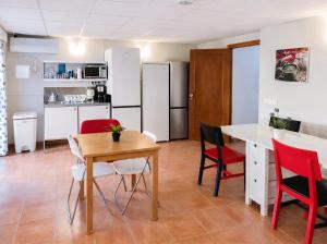 a kitchen and dining room with a table and chairs at Sun Serramar Boutique Hostal in Benalmádena