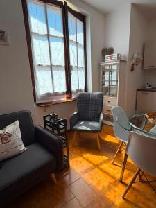 a living room with a couch and a table and chairs at Cottage di Lola in Fonteno