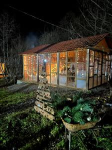 a building with a christmas display in front of it at Jvarisa Glamping in Ambrolauri