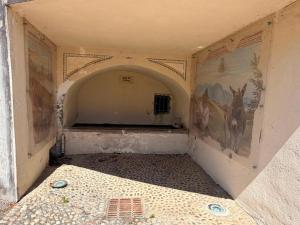 an empty room with paintings of horses on the wall at Cottage di Lola in Fonteno