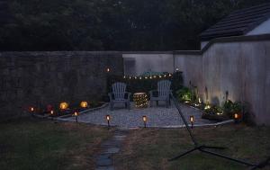 a backyard with two chairs and candles and lights at An Tuar Ceatha in Castlebar
