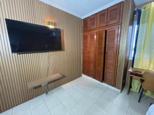 a room with a flat screen tv on a wall at Lux meublé in Douala +7 photos