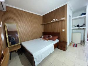 a bedroom with a bed and a mirror at Lux meublé in Douala
