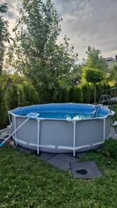 a large hot tub in the grass in a yard at Eco Villa, A frame with barbecue zone and pool in Yerevan