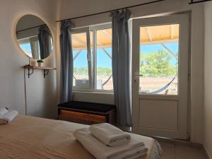 a bedroom with a bed and a mirror and a window at KRAPEC Beach in Krapets